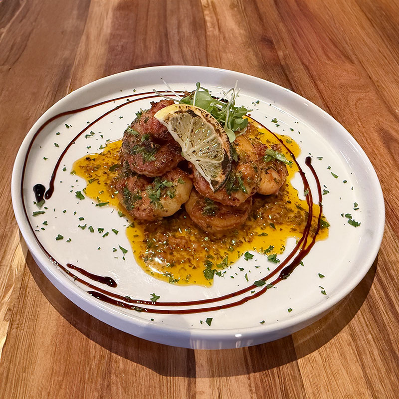 Eight jumbo shrimp in our house-made garlic brandy sauce, served with toasted baguette